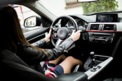 Young woman drives a luxury car