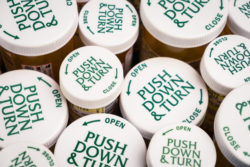 Childproof tops of many prescription bottle of medication