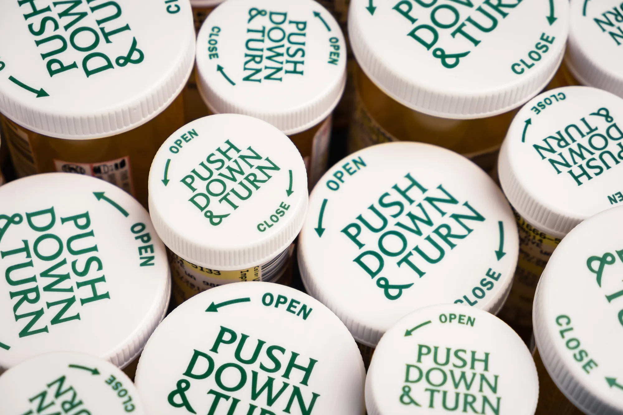 Childproof tops of many prescription bottle of medication