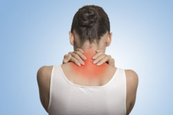 Unum disability fibromyalgia woman rubbing shoulders