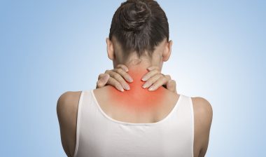 Unum disability fibromyalgia woman rubbing shoulders