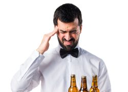 frustrated waiter with beer bottles on the tray