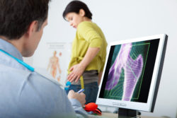 Models. On screen, result of an osteodensitometry of the hip with an osteoporosis.