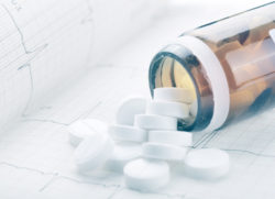 Medical concept with pills on ECG paper.