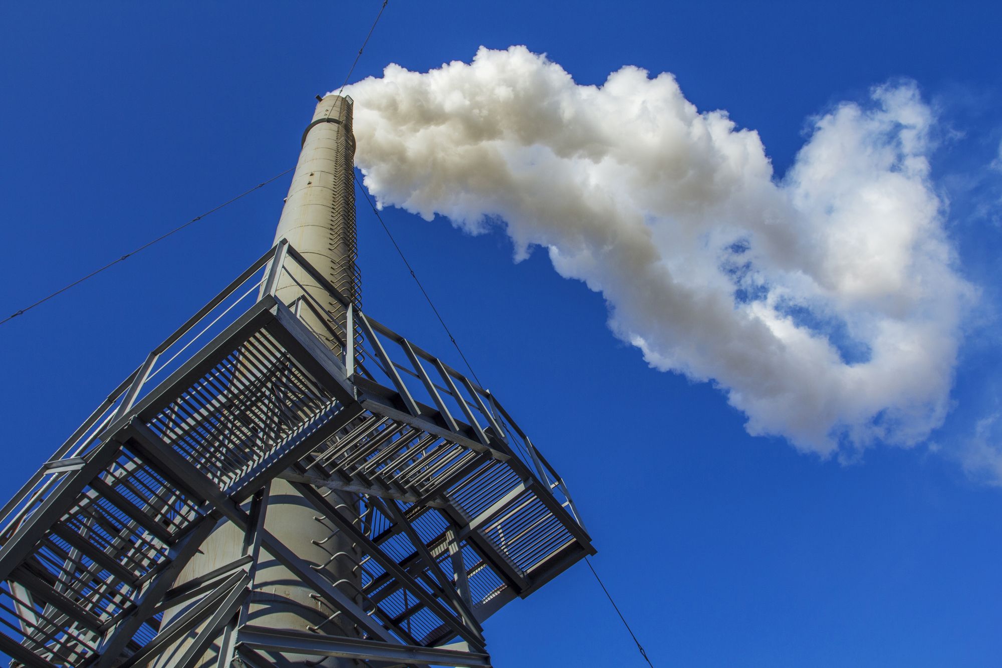 White cloud of smoke from the high smokestack.