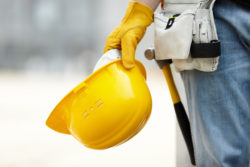 asbestos mesothelioma construction worker yellow hard hat