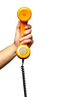 Close Up Of Hand Holding Telephone against a white background