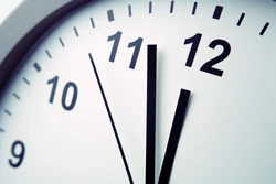 Closeup of hands on clock face