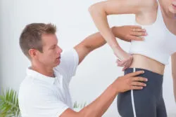 Doctor examining his patient back in medical office