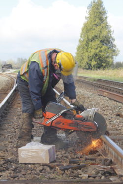 Crew with Canadian National Railway repair railway tracks.