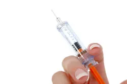 Woman's Hand Holding Syringe