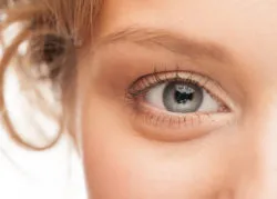 Close-up shot of woman eye with beautiful makeup looking at camera