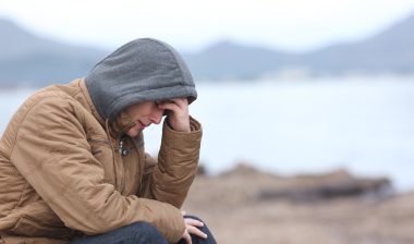 Worried teenage boy crying on the beach in winter , risperdal,