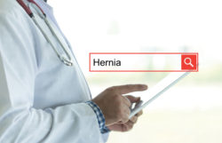 DOCTOR USING TABLET PC AND SEARCHING HERNIA ON WEB