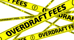 Yellow warning tapes with inscription "OVERDRAFT FEES" on the white surface. Isolated. 3D Illustration