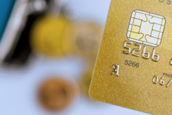 a gold credit card and an empty wallet. symbolic photo for cashless transactions and status symbols.