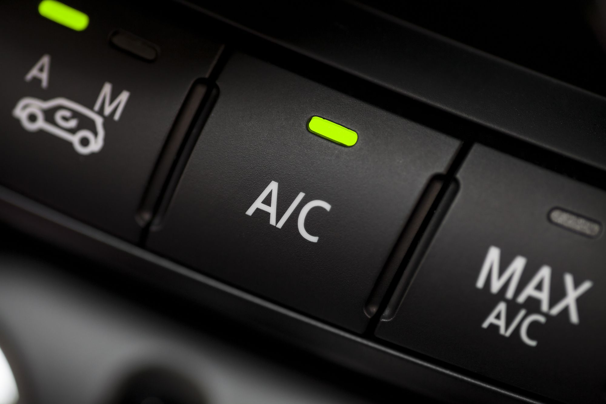 Color detail with the air conditioning button inside a car.