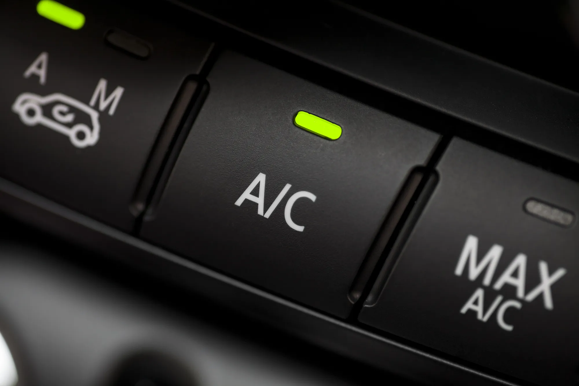 Color detail with the air conditioning button inside a car.