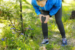 Injuries - sports running knee injury on woman