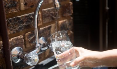 Belmont N.C. water faucet pouring water into glass