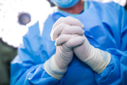 Surgeon praying in operation room while operation at hospital