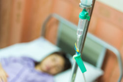 Woman patient sleeping in hospital bed.