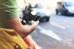 man looking at phone, robocalls