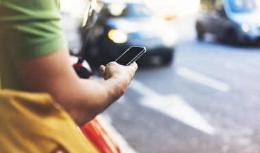 man looking at phone, robocalls