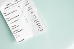 paying check for lunch on glass table background. Lucky number to pay. Vegetarian food was in order