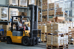 Busy warehouse with pallet trucks working