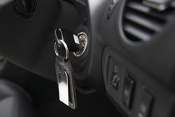 Automobile key inserted into the lock of ignition of the car