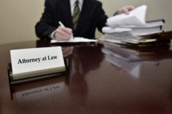 Attorney at Law sitting at desk