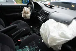 Detail of damaged car with deployed airbags