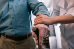 long term care insurance senior man nurse cane