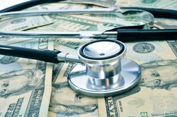 surprise medical bills stethoscope and cash