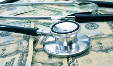 surprise medical bills stethoscope and cash
