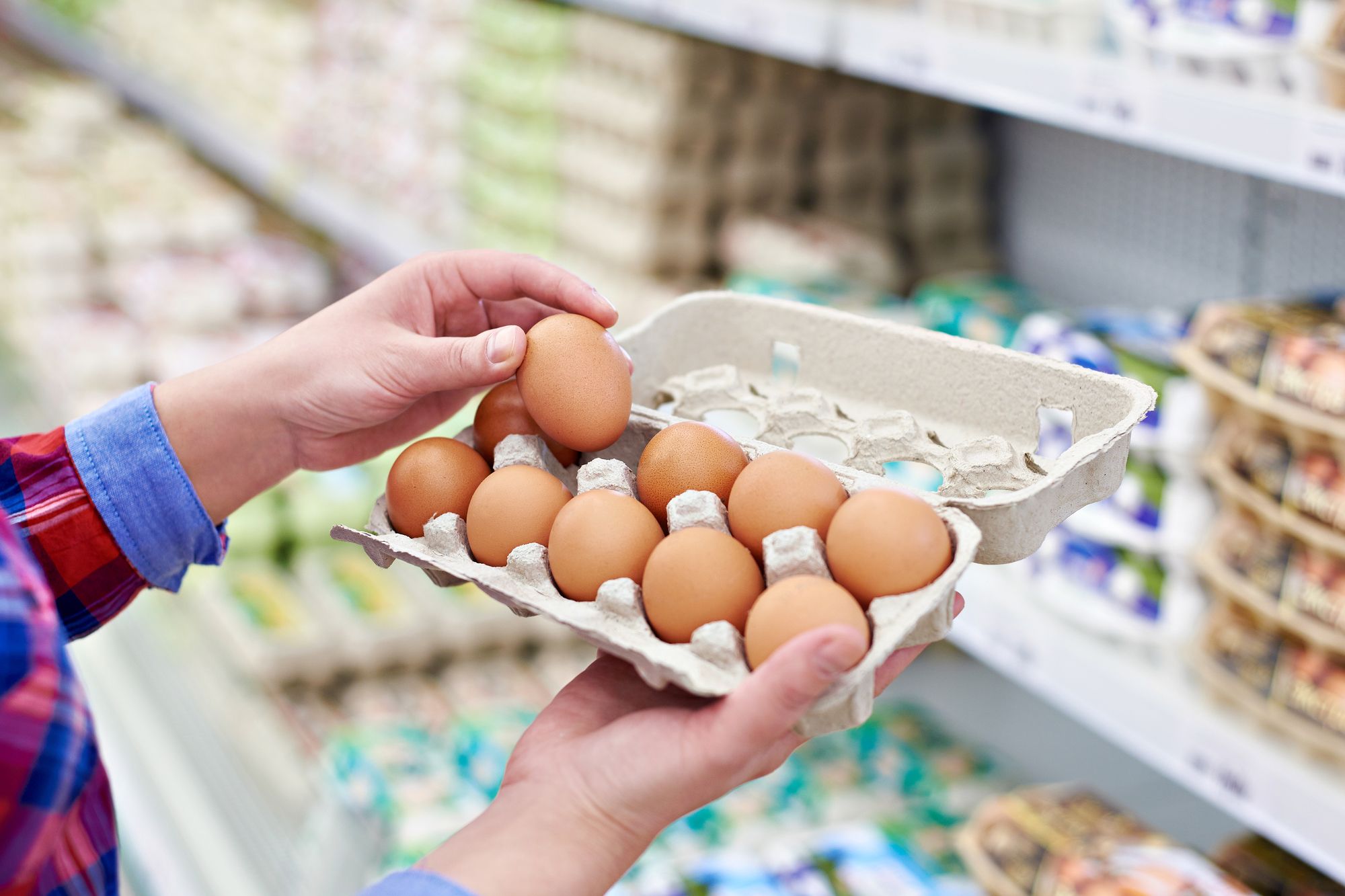 In the hands of a woman packing eggs in the supermarket