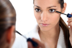 Rodan and Fields Lash Boost Woman applying eye make-up