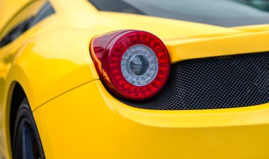 Ferrari odometer Close-up view of yellow sports car rear light.