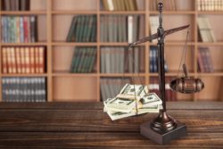 scales of justice with money