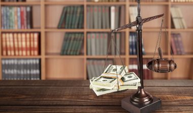 scales of justice with money