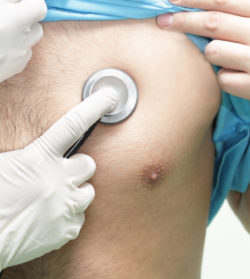 Doctor listens to a patient with a stethoscope.