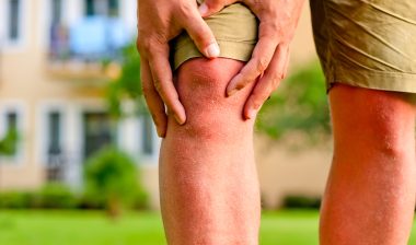 man holding sore knee