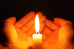 burning candle isolated on black background