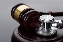 Close-up Of Brown Gavel And Medical Stethoscope