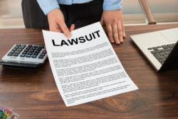 Close-up Lawyer Showing The Document With The Text Lawsuit