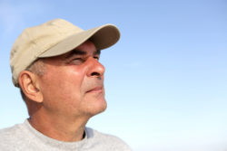 Portrait of a senior man on the sky background
