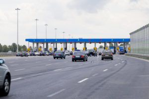 electronic toll road fees cars approaching toll booth