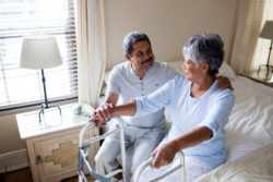 Dilantin cerebellar atrophy couple sitting on bed with walker