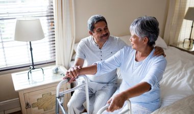 Dilantin cerebellar atrophy couple sitting on bed with walker